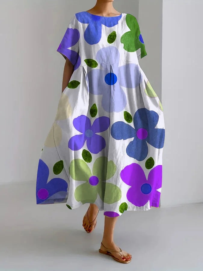 Woman enjoying a sunny day outdoors, wearing a flattering blue floral dress with an adjustable waist.