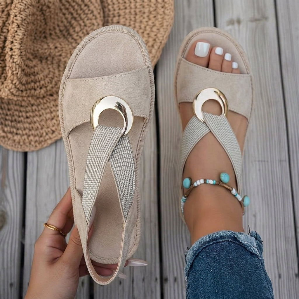A person wearing stylish blue sandals, walking outdoors on a sunny day, demonstrating all-day comfort.