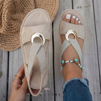 A person wearing stylish blue sandals, walking outdoors on a sunny day, demonstrating all-day comfort.