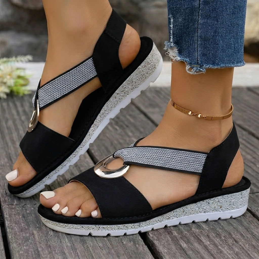 Three pairs of orthopedic sandals in different colors (beige, black, blue) arranged side by side.