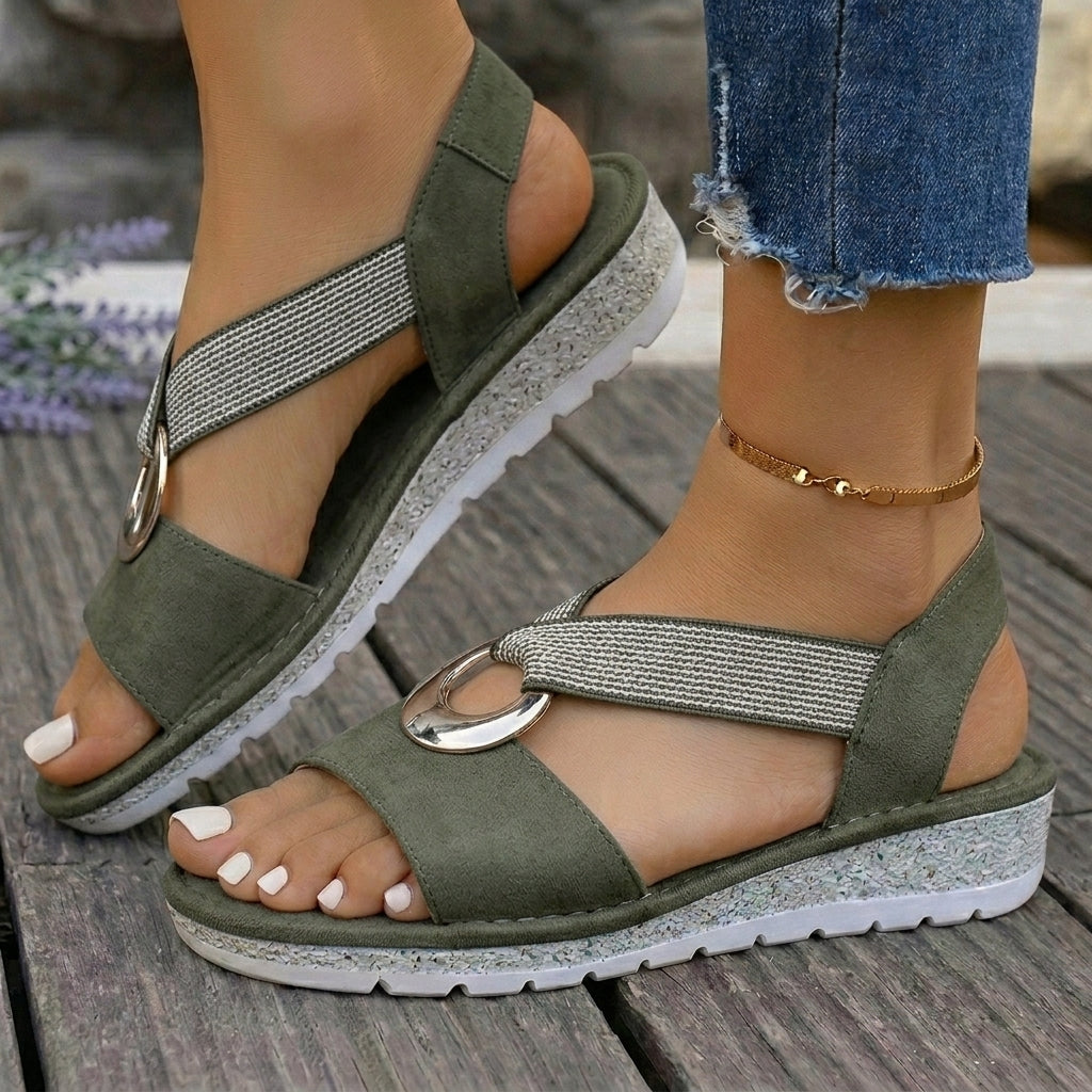 Side profile of black orthopedic sandals on a neutral background, highlighting the ergonomic insole and heel support.