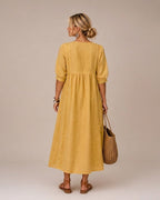 A collection of the midi dresses in various vibrant colors, neatly arranged to display their full range of hues.