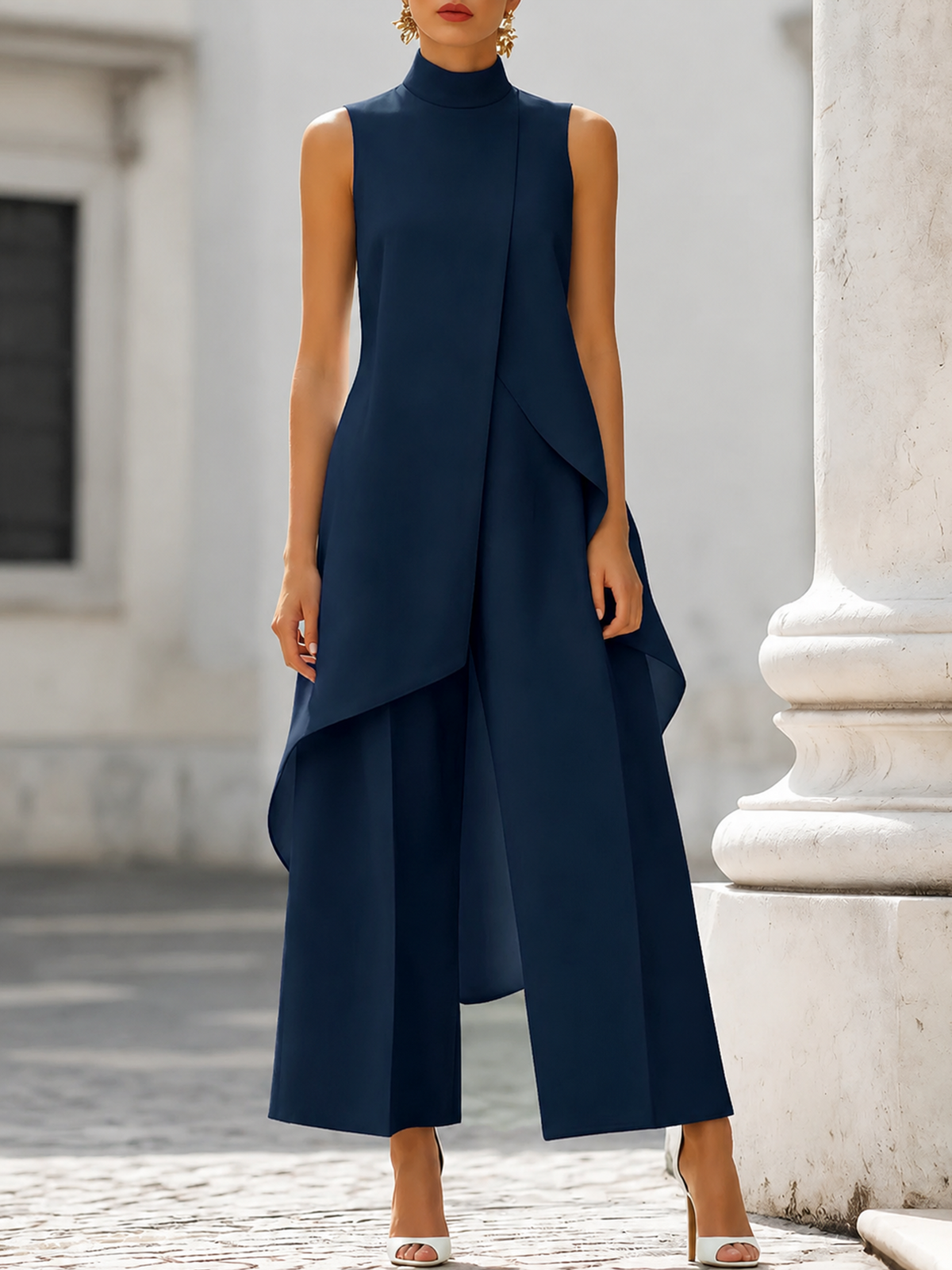 Detail shot of the asymmetric front panel on the pink jumpsuit, adding movement and refinement.