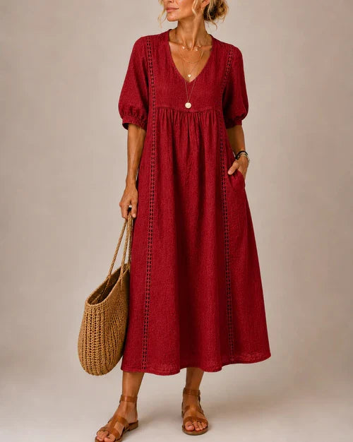 Rear view of the stylish midi dress, showcasing its relaxed fit and graceful movement as a woman walks.