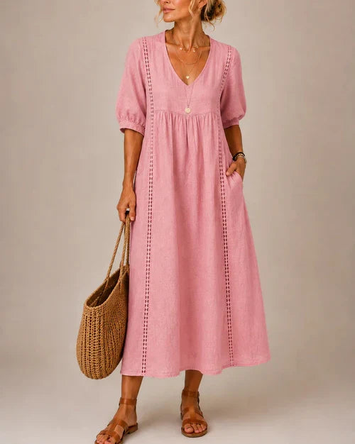 A woman enjoying a sunny day, twirling slightly in the comfortable natural fabric midi dress, feeling carefree.